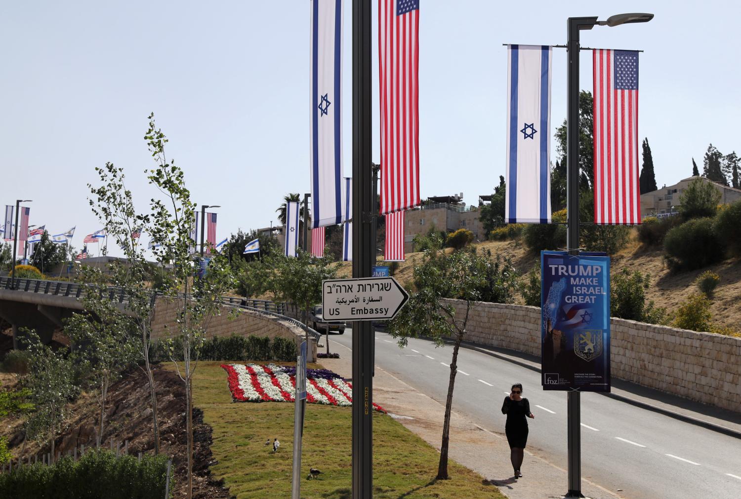 A woman walks next to a road sign directing to the U.S. embassy, in the area of the U.S. consulate in Jerusalem, May 11, 2018. REUTERS/Ammar Awad - RC190ACBAC00
