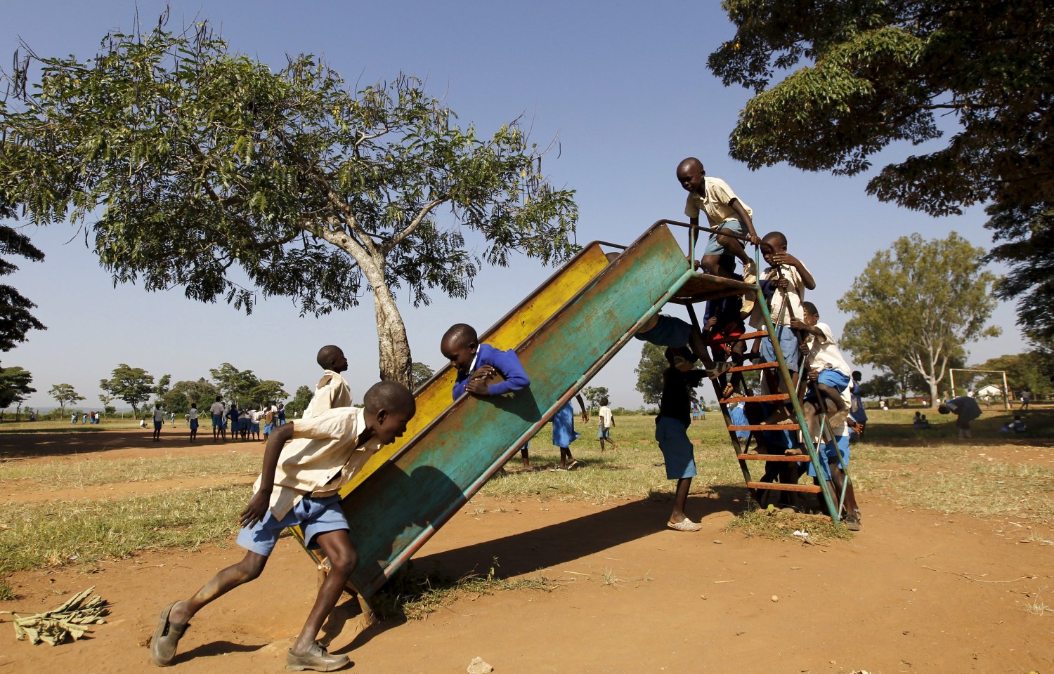 Pupils play during breaktime at the Senator Obama primary school in the village of Nyang'oma Kogelo, west of Kenya's capital Nairobi, July 16, 2015. U.S. President Barack Obama visits Kenya and Ethiopia later this month. His ancestral home of Kogelo is home to Sarah Hussein Obama, his step-grandmother. The Kenyan village, burial place of Obama's father, features an open-pit goldmine, a pork butcher's, a school named after their most famous son and outdoor market stalls. Villagers get around by motorbike taxi or on foot while a donkey-cart transports water. Children, some of them named Obama in honour of the President, walk to and from school together. Picture taken July 16, 2015. REUTERS/Thomas MukoyaPICTURE 17 OF 35 FOR WIDER IMAGE STORY "KOGELO, KENYA - OBAMA'S ANCESTRAL HOME". SEARCH "ANCESTRAL MUKOYA" FOR ALL IMAGES - GF10000166803