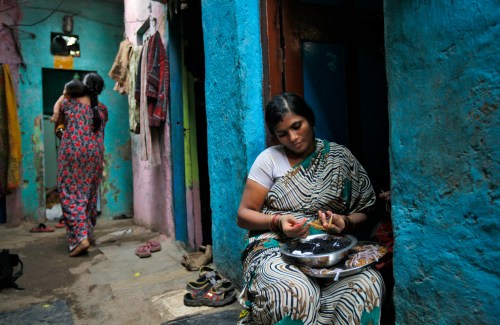 Shobha Vakade, 28, who took a loan of rupees 18,000 ($400) from a micro finance company to start her own business, strings beads into necklaces outside her house in a slum in Mumbai October 26, 2010. India's microfinance industry, which surged to prominence when George Soros-backed SKS Microfinance raised $358 million in an IPO, faces a regulatory clampdown that could erode profits and hurt growth. Reports of dozens of suicides by poor borrowers in the southern state of Andhra Pradesh, the hub of India's microfinance sector, prompted the state to enact an rules against aggressive recovery practices by lenders who make loans that average about $150 to poor customers at interest rates that can top 30 percent. Picture taken October 26, 2010.       To match analysis INDIA-MICROFINANCE/      REUTERS/Danish Siddiqui (INDIA - Tags: SOCIETY BUSINESS) - GM1E6AS11VO01