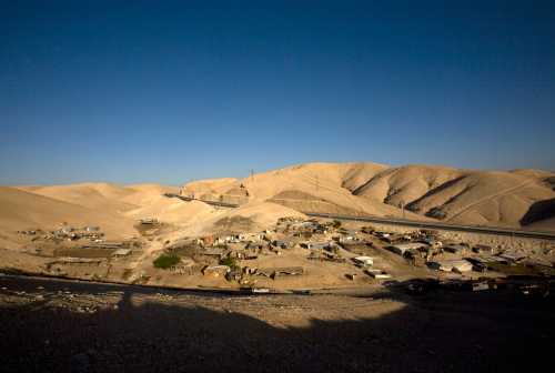 Makeshift structures are seen at a bedouin encampment south of the West Bank Jewish settlement of Mishor Adumim in the Judean Desert August 19, 2009. Many bedouins living in Israel and the occupied West Bank retain a traditional and nomadic way of life, raising livestock and farming arid land.  REUTERS/Ronen Zvulun (WEST BANK POLITICS SOCIETY) - GM1E58K00LD01