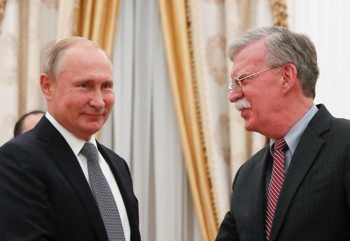 Russian President Vladimir Putin (L) greets U.S. National Security Adviser John Bolton during a meeting at the Kremlin in Moscow, Russia October 23, 2018. REUTERS/Maxim Shemetov - RC17C28C2550