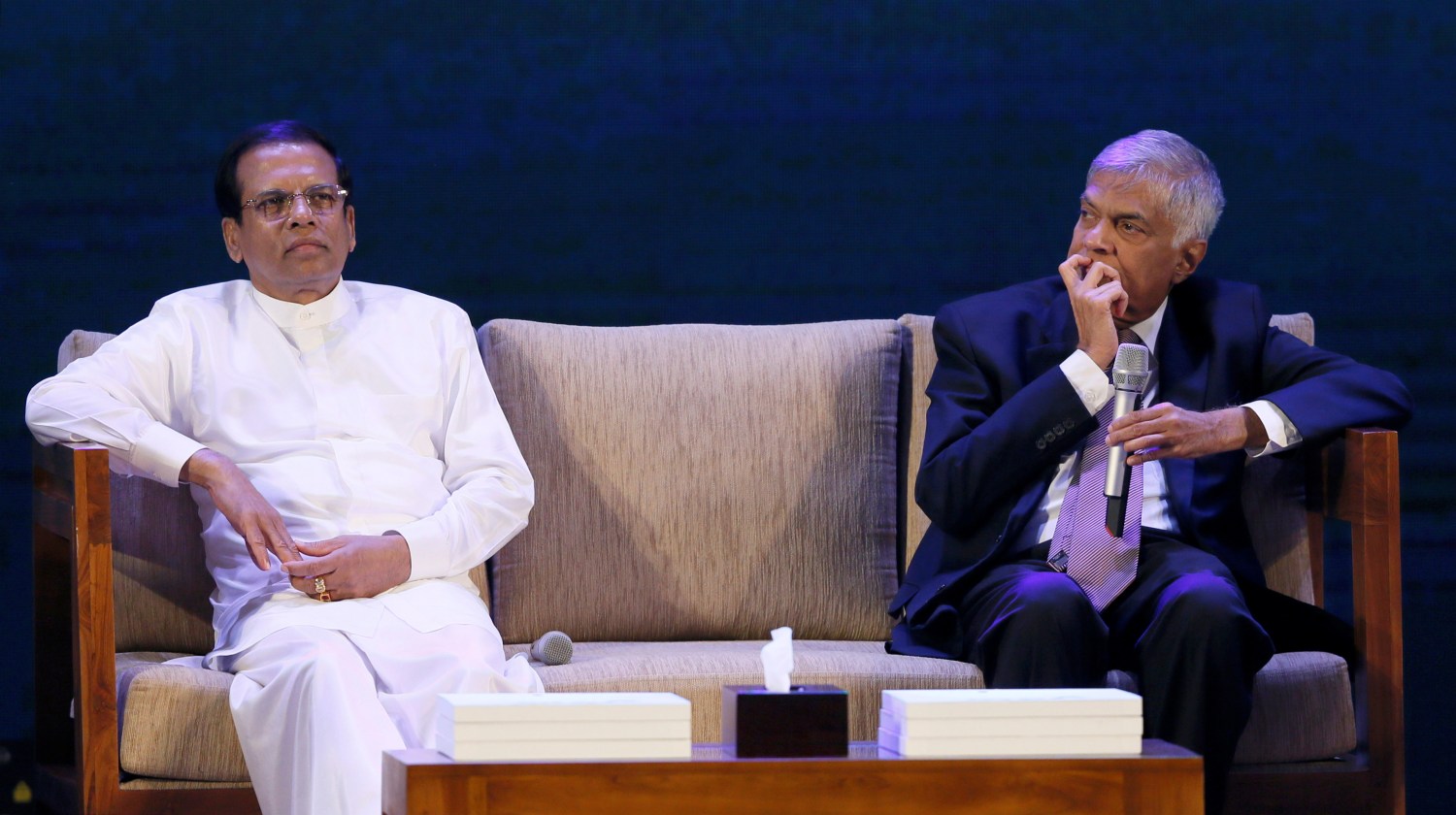 Sri Lanka's Prime Minister Ranil Wickremesinghe looks on next to Sri Lanka's President Maithripala Sirisena during the "Vision 2025" future plans of Sri Lanka launching ceremony in Colombo, Sri Lanka September 4, 2017. REUTERS/Dinuka Liyanawatte - RC166B794690