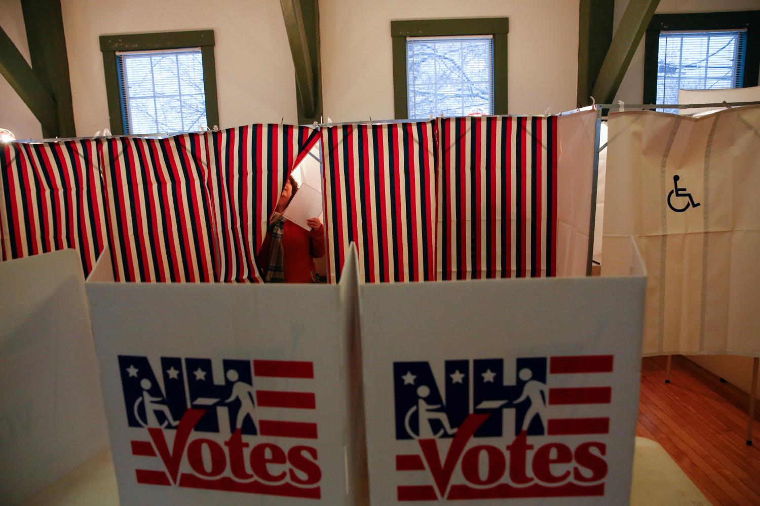A woman leaves a voting station in a polling place at the Canterbury Town Hall polling station in Canterbury, New Hampshire February 9, 2016. REUTERS/Shannon Stapleton - D1BESMAVHBAB