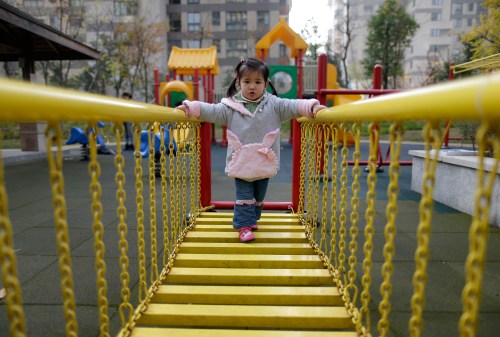 A child walks on a swinging bridge at a kindergarten in Wuhan, Hubei province, December 3, 2012. Expectations are now high that China could relax the one-child policy, or even implement a universal two-child policy such as the one in Jiuquan. Outgoing President Hu Jintao, for the first time, conspicuously dropped the phrase "maintain a low birth rate" in his work report to the Chinese Communist Party's twice a decade congress in November. That foreshadows a change to the one-child ethos, according to Ji Baocheng, a delegate to China's rubber stamp parliament who has petitioned five times for a change in the policy. Picture taken December 3, 2012. REUTERS/Stringer (CHINA - Tags: POLITICS SOCIETY EDUCATION) CHINA OUT. NO COMMERCIAL OR EDITORIAL SALES IN CHINA - GM1E91M0E8Y01