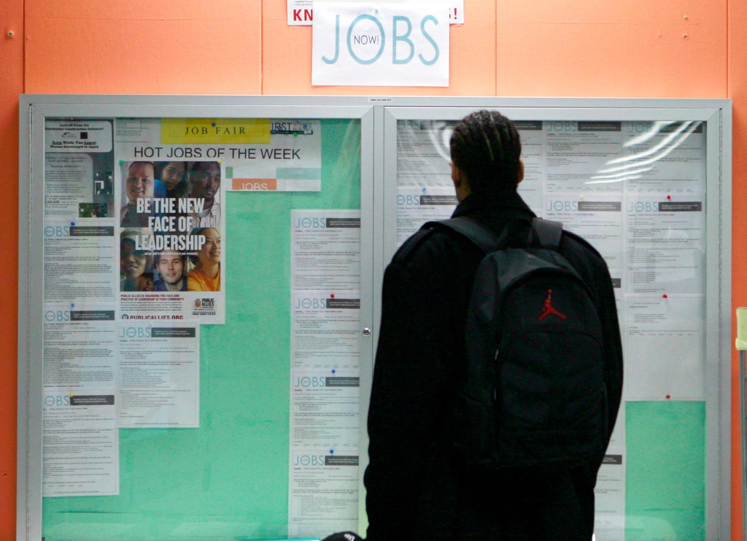 A man looks over employment opportunities at a jobs center in San Francisco, California, in this February 4, 2010 file photo. The number of people filing new claims for unemployment insurance unexpectedly rose in the latest week to its highest level in close to six months, the U.S. Labor Department said on Thursday, August 12, 2010. The number of new claims for jobless benefits rose 2,000 to 484,000 in the week ended August 7, the second straight increase. REUTERS/Robert Galbraith/Files  (UNITED STATES - Tags: BUSINESS EMPLOYMENT SOCIETY) - GM1E68C1MMJ01