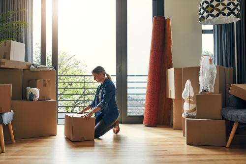 Woman inside home packing and moving