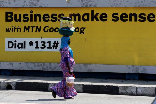 FILE PHOTO: A woman walks past an advertising poster for MTN telecommunication company along a street in Lagos, Nigeria October 30, 2018. REUTERS/Afolabi Sotunde/File Photo - RC15DB15CAF0