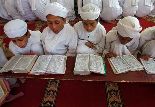 Boys read the Koran inside Markaz Al-Madrasa Al-Islamia, an Islamic seminary and orphanage, during the Muslim fasting month of Ramadan in Shadipora on the outskirts of Srinagar May 20, 2018. REUTERS/Danish Ismail - RC14F69A05E0