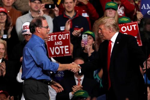 U.S. President Donald Trump shakes hands with Republican candidate for U.S. Senate Mike Braun during a campaign rally at Southport High School in Indianapolis, Indiana, U.S. November 2, 2018.  REUTERS/Carlos Barria - RC1E86AB4B90
