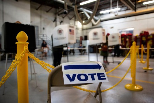 A sign points towards voting booths during the midterm election at Philomont Fire Station, in Purcellville, Virginia, U.S., November 6, 2018. REUTERS/Al Drago - RC1C4591A6A0