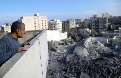 A Palestinian looks at the remains of a building that was destroyed by Israeli air strikes, in Gaza City November 13, 2018. REUTERS/Suhaib Salem - RC1FF211E190