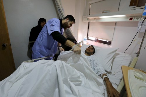 An injured man, who was among the people evacuated on Monday from the two Syrian besieged Shi'ite towns of al-Foua and Kefraya, receives treatment at a hospital in Beirut's southern suburbs, Lebanon December 29, 2015. A U.N. operation to evacuate around 450 Syrian fighters and their families from two besieged Syrian areas was completed on Monday with the arrival of planes carrying them to Beirut and Hatay airport in Turkey, U.N. and airport sources said. REUTERS/Aziz Taher - GF10000277887