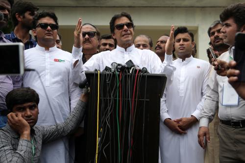 Cricket star-turned-politician Imran Khan, chairman of Pakistan Tehreek-e-Insaf (PTI), speaks to members of media after casting his vote at a polling station during the general election in Islamabad, Pakistan, July 25, 2018. REUTERS/Athit Perawongmetha - RC1799F93F60