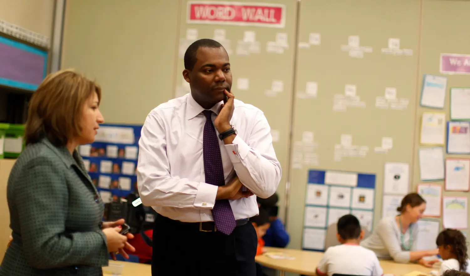 Chicago Public Schools CEO Jean-Claude Brizard speaks with Disney II Elementary School principal Bogdana Chkoumbova in Chicago, September 26, 2011. Disney is one of 13 Chicago public schools which have decided to be early adopters of a plan to add 90 minutes to the school day, a scheme pushed hard by new Mayor Rahm Emanuel who says it is necessary to improve the city's K-12 education. Picture taken September 26, 2011. REUTERS/Jim Young  (UNITED STATES - Tags: EDUCATION POLITICS SOCIETY BUSINESS EMPLOYMENT) - GM1E79T06IA01