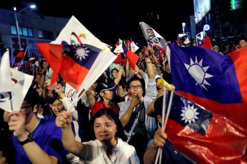 Supporters of Opposition Nationalist Kuomintang Party (KMT) Kaohsiung mayoral candidate Han Kuo-yu celebrate as Han won from local elections, in Kaohsiung, Taiwan November 24, 2018. REUTERS/Tyrone Siu - RC1A9683ED30