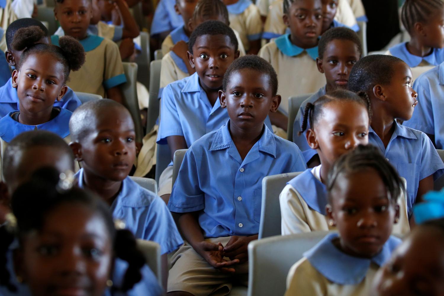 Children sit in a classroom before Prince Harry arrives for a tour of Holy Trinity Primary school during his official visit to Codrington, Barbuda, November 22,  2016.   REUTERS/Carlo Allegri - S1AEUOJGFBAA