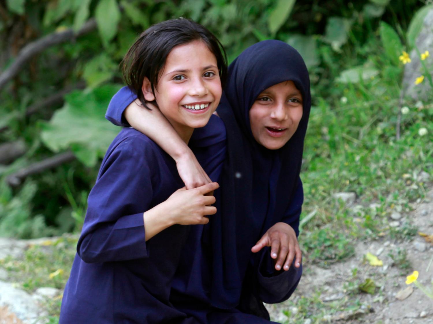 Kashmiri school girls react to the camera while walking back home after their class at Kanzalwan near the Line of Control in Gurez sector, 160 km (99 miles) north of Srinagar June 21, 2012. The Line of Control, or a military ceasefire line, divides India and Pakistan in Kashmir. REUTERS/Fayaz Kabli (INDIAN-ADMINISTERED KASHMIR - Tags: SOCIETY EDUCATION) - GM1E86M04E001