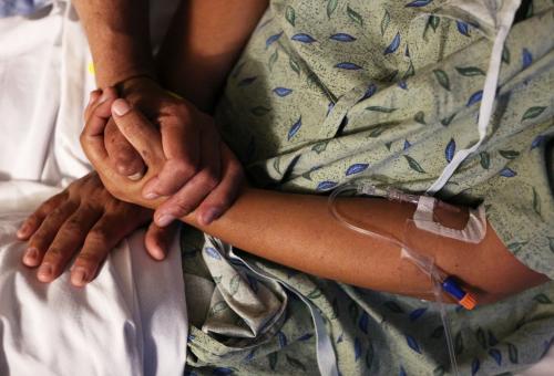 A patient is comforted by her husband at St. Joseph's Hospital in Tucson, Arizona, U.S. September 13, 2017. They were enrolled in health insurance thanks to Maria Losoya, a University of Arizona Center for Rural Health Navigator. Photo taken September 13, 2017.     REUTERS/Caitlin O'Hara - RC14E813EA30