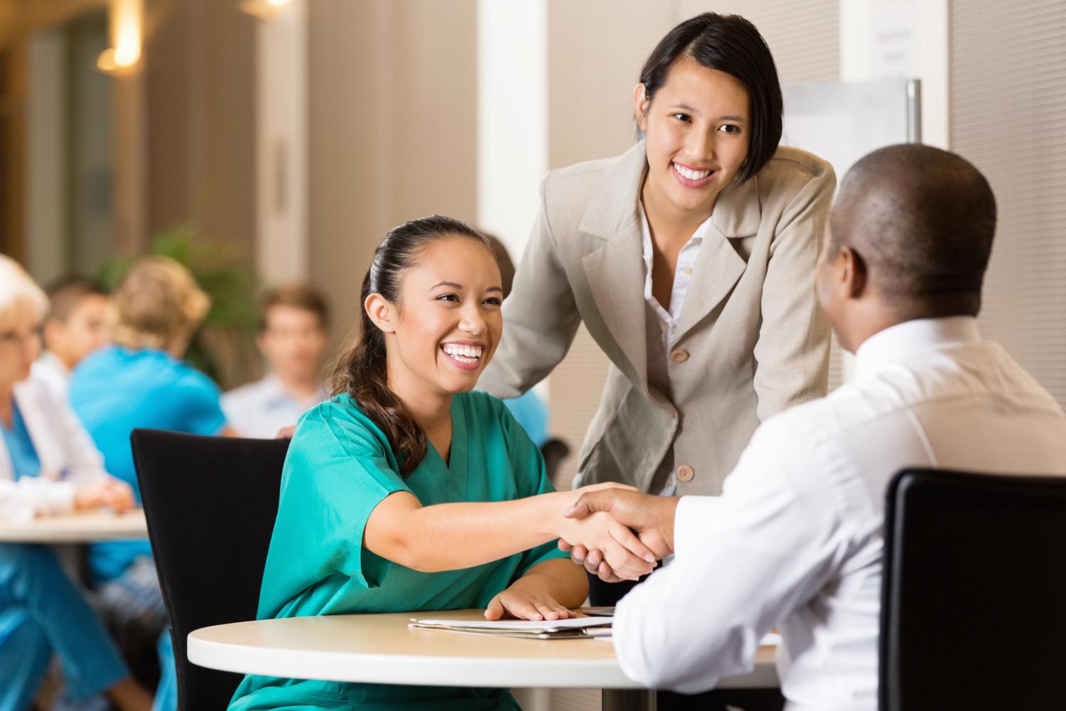 Hospital employee conducting job interview with nurse