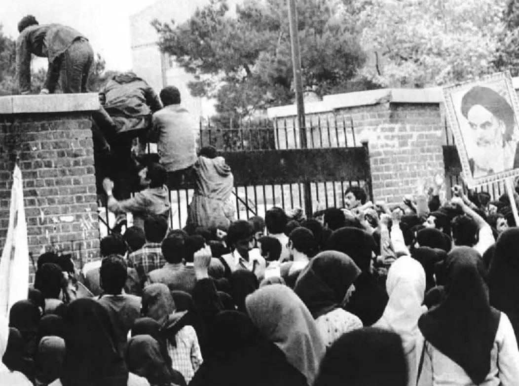 Student protestors climb over the gate to the U.S. Embassy in Tehran on November 4, 1979. / Wikimedia Commons