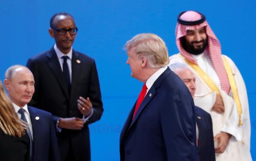 U.S. President Donald Trump walks past Russia's President Vladimir Putin, Rwandan President and African Union chairperson Paul Kagame, Saudi Crown Prince Mohammed bin Salman and Brazil's President Michel Temer as he arrives for a family photo during the G20 leaders summit in Buenos Aires, Argentina November 30, 2018. REUTERS/Kevin Lamarque - RC171E986680