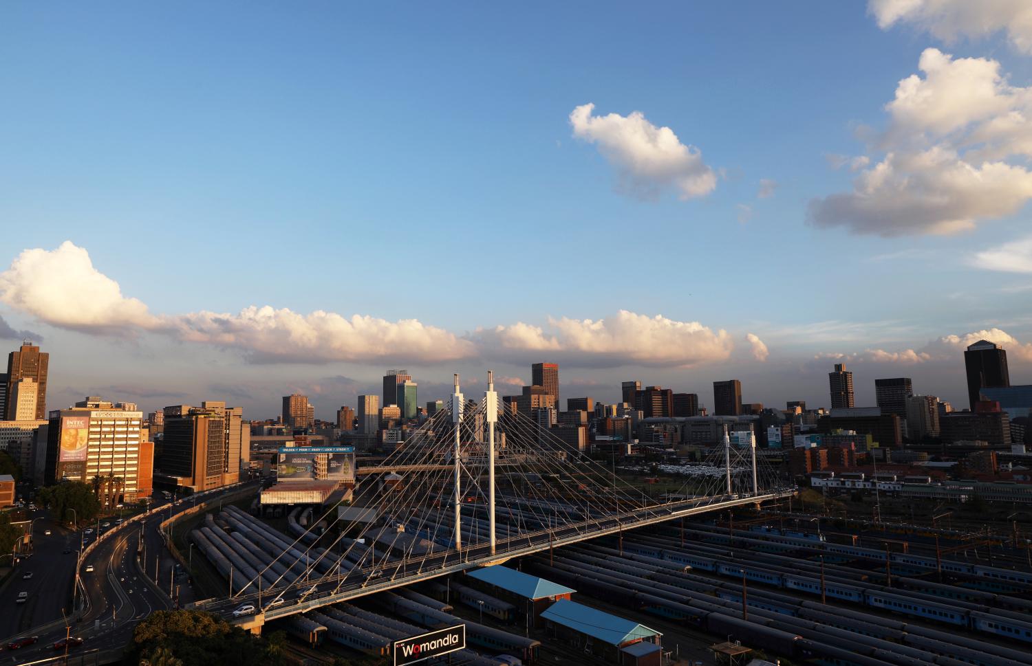 The city of Johannesburg over looks the Mandela bridge, with trains parked underneath in Johannesburg, South Africa, November 29, 2018. REUTERS/Siphiwe Sibeko - RC1A1A80F7F0