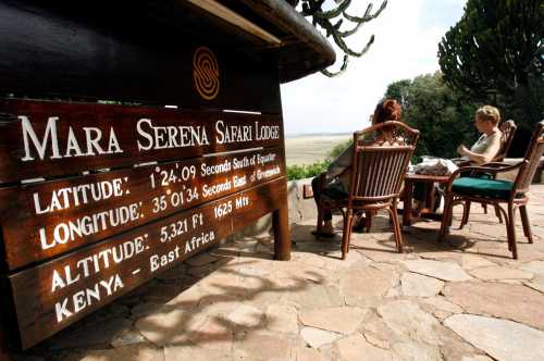 Tourists sit at the Mara Serena Safari Lodge, within the Masai Mara game reserve, southwest of Nairobi, Kenya, July 28, 2009. Picture taken July 28, 2009. REUTERS/Thomas Mukoya - RC1A8B82F4A0