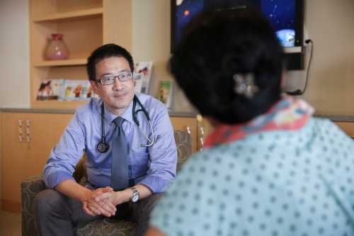 Dr. Larry Kwan speaks with an employee during a doctor's visit at a Cisco health clinic at Cisco Systems in San Jose, California, U.S., March 22, 2018. Picture taken March 22, 2018. REUTERS/Elijah Nouvelage - RC187BA06000