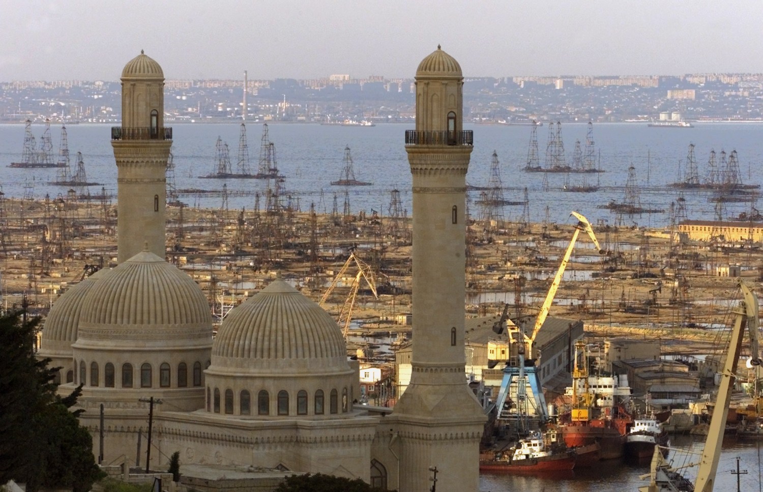 View of Bibi Heybat Mosque and a Caspian sea shore with oil rigs inBaku May 20, 2002. Pope John Paul II is going to visit the capital ofex-Soviet state Azerbaijan May 22-23. REUTERS/Shamil ZhumatovSZH/CLH/ - RP3DRHZLHUAB