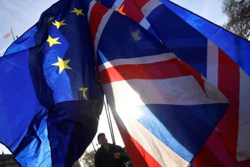 Demonstrators hold EU and Union flags during an anti-Brexit protest opposite the Houses of Parliament in London, Britain, December 17, 2018. REUTERS/Toby Melville - RC14C86B4D80