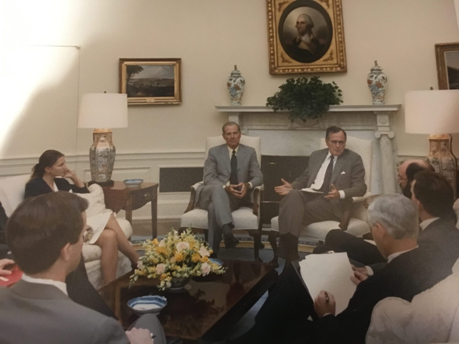President George H.W. Bush leads a discussion about Iraqi President Saddam Hussein in the Oval Office in the fall of 1990. CIA Officer Bruce Riedel is responding to the president.