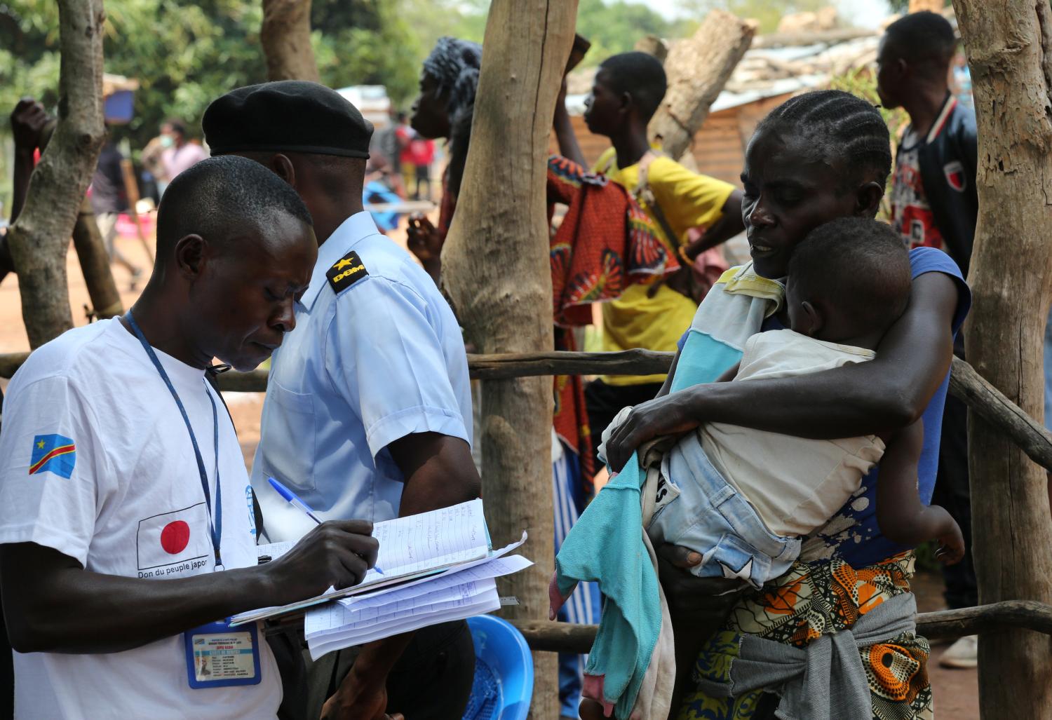 An official from the International Organization for Migration (IOM) collects data and registers a Congolese migrant who crossed from Angola at the Kamako border, Kasai province in the Democratic Republic of the Congo, October 13, 2018. Picture taken October 13, 2018. REUTERS/Giulia Paravicini - RC1D32E4EC70