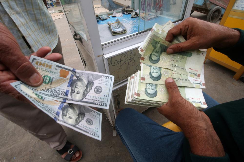 Iranian rials, U.S. dollars and Iraqi dinars are seen at a currency exchange shop in Basra, Iraq November 3, 2018. Picture taken November 3, 2018. REUTERS/Essam al-Sudani - RC18BD110300