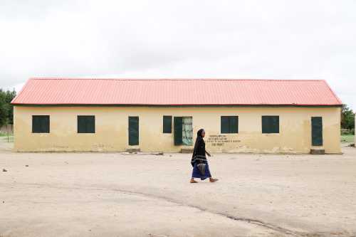 A woman walks past the Hausari primary school in Michika village, northeast Nigeria June 12, 2017. Picture taken June 12, 2017. REUTERS/Akintunde Akinleye - RC1AFAC79A10