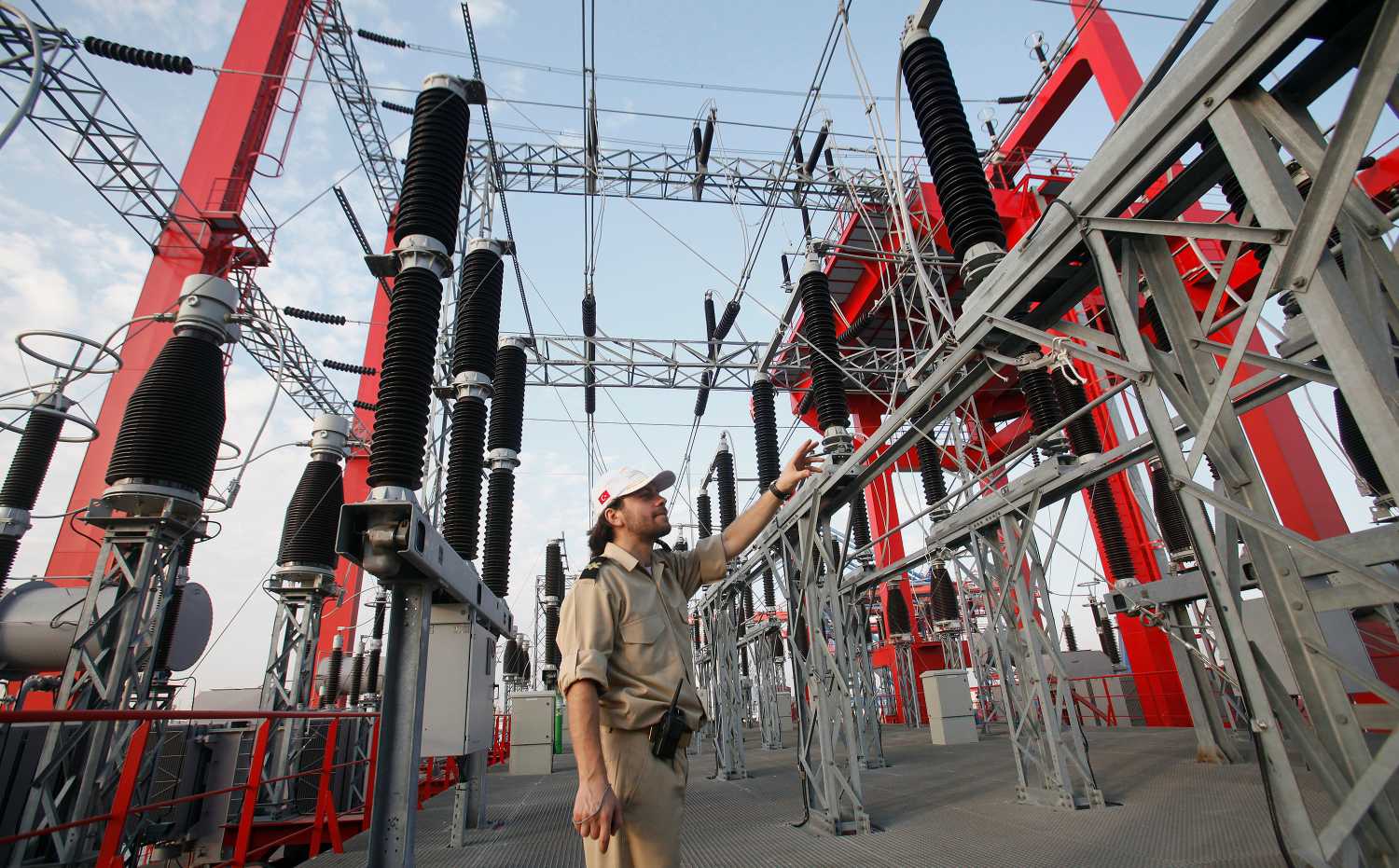 A Turkish official points while giving a tour to media of the Turkish-made power ship 'Kaya Bey' after a dedication ceremony at Karachi Port on November 21, 2010. The Turkish-made power plant aboard the vessel will feed 232 megawatts to the national grid within a month, local media reported. REUTERS/Akhtar Soomro (PAKISTAN - Tags: POLITICS ENERGY) - GM1E6BL1QP501
