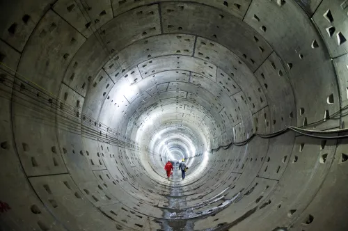 Workers walk along a tunnel of a subway construction site in Changsha, Hunan province, China, October 11, 2015. Picture taken October 11, 2015. REUTERS/Stringer/File Photo CHINA OUT. NO COMMERCIAL OR EDITORIAL SALES IN CHINA   - S1AETNOYSNAA
