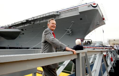 Former President George H.W. Bush walks the gangway as he arrives for the christening ceremony of the USS George H.W. Bush at Northrop-Grumman's shipyard in Newport News, Virginia in this October 7, 2006 file photo. The Navy's Nimitz-class aircraft carrier is scheduled to enter service in late 2008.   REUTERS/Kevin Lamarque/Files  (UNITED STATES - Tags: POLITICS) - TM3E8BU1BPV01