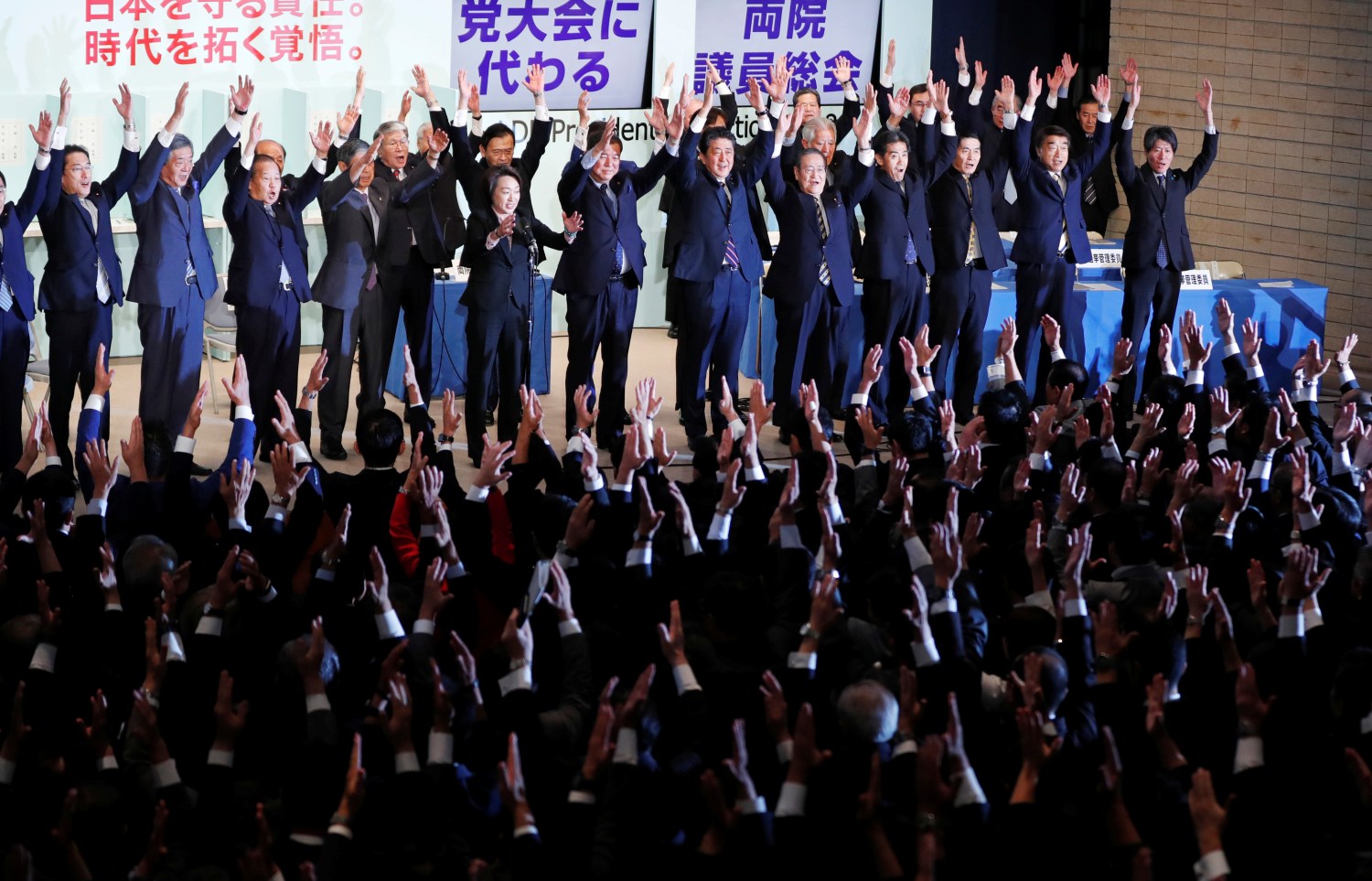 Japan's Prime Minister Shinzo Abe (C), who is also the ruling Liberal Democratic Party's (LDP) leader, shouts 'Banzai' (cheers) as he raises his hands with members of LDP after winning the leadership vote at the party's headquarters in Tokyo, Japan  September 20, 2018.   REUTERS/Toru Hanai - RC1FA0EC7870