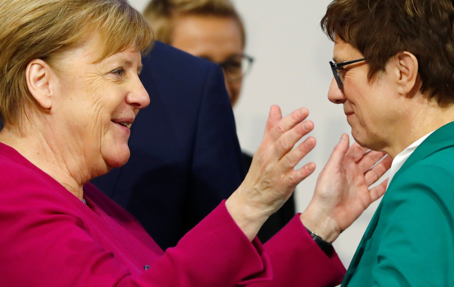 New CDU leader Annegret Kramp-Karrenbauer and German Chancellor Angela Merkel bid farewell to each other during the closing of Christian Democratic Union (CDU) party congress in Hamburg, Germany, December 8, 2018. REUTERS/Kai Pfaffenbach - RC158EEE7F30