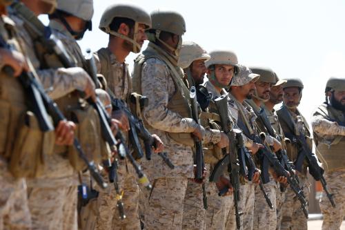 Saudi soldiers stand in line at an airfield where Saudi military cargo planes land to deliver aid in Marib, Yemen January 26, 2018. Picture taken January 26, 2018. REUTERS/Faisal Al Nasser - RC1D0C8D9D00