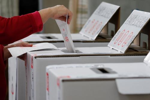 A woman casts her ballots at a polling station during local elections and referendum on same-sex marriage, in Kaohsiung, Taiwan November 24, 2018. REUTERS/Tyrone Siu