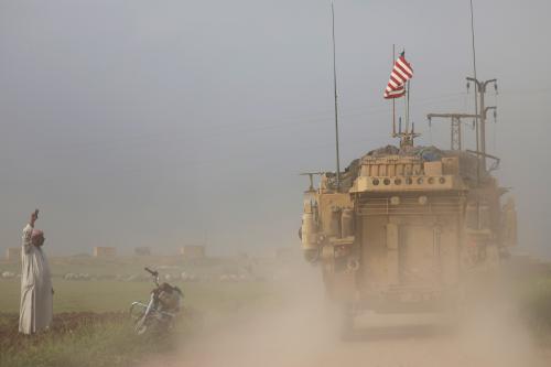 A man gestures at U.S military vehicles driving in the town of Darbasiya next to the Turkish border, Syria April 28, 2017. REUTERS/Rodi Said     TPX IMAGES OF THE DAY - RC15AC3FC730