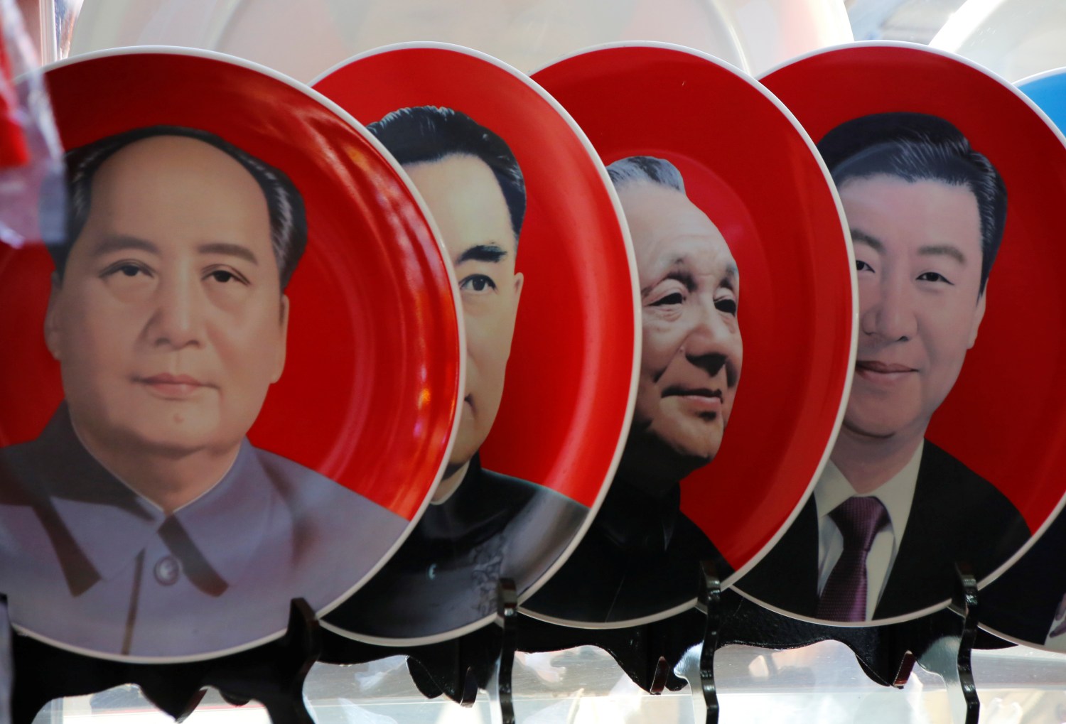 Souvenir plates featuring portraits of current and late Chinese leaders (R-L) Xi Jinping, Deng Xiaoping, Zhou Enlai and Mao Zedong are displayed for sale at a shop next to Tiananmen Square in Beijing, China, March 1, 2018. REUTERS/Jason Lee - RC1F3D851180