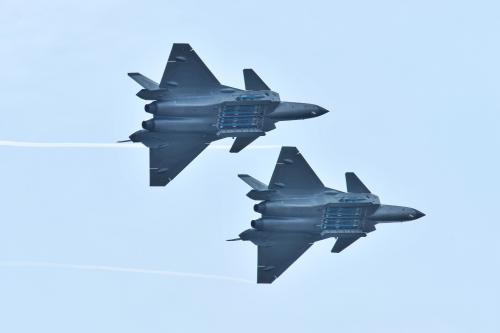 Chengdu J-20 stealth fighter jets of Chinese People's Liberation Army (PLA) Air Force perform with open weapon bays during the China International Aviation and Aerospace Exhibition, or Zhuhai Airshow, in Zhuhai, Guangdong province, China November 11, 2018. REUTERS/Stringer ATTENTION EDITORS - THIS IMAGE WAS PROVIDED BY A THIRD PARTY. CHINA OUT. - RC12CF4CDC00