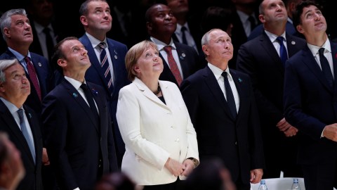 United Nation Secretary-General Antonio Guterres, French President Emmanuel Macron, German Chancellor Angela Merkel, Russian President Vladimir Putin and Canadian Prime Minister Justin Trudeau look up for a family photo at the opening of the opening of the Paris Peace Forum after the commemoration ceremony for Armistice Day, 100 years after the end of the First World War, in Paris, France November 11, 2018. Yoan Valat/Pool via REUTERS - RC13102CF520