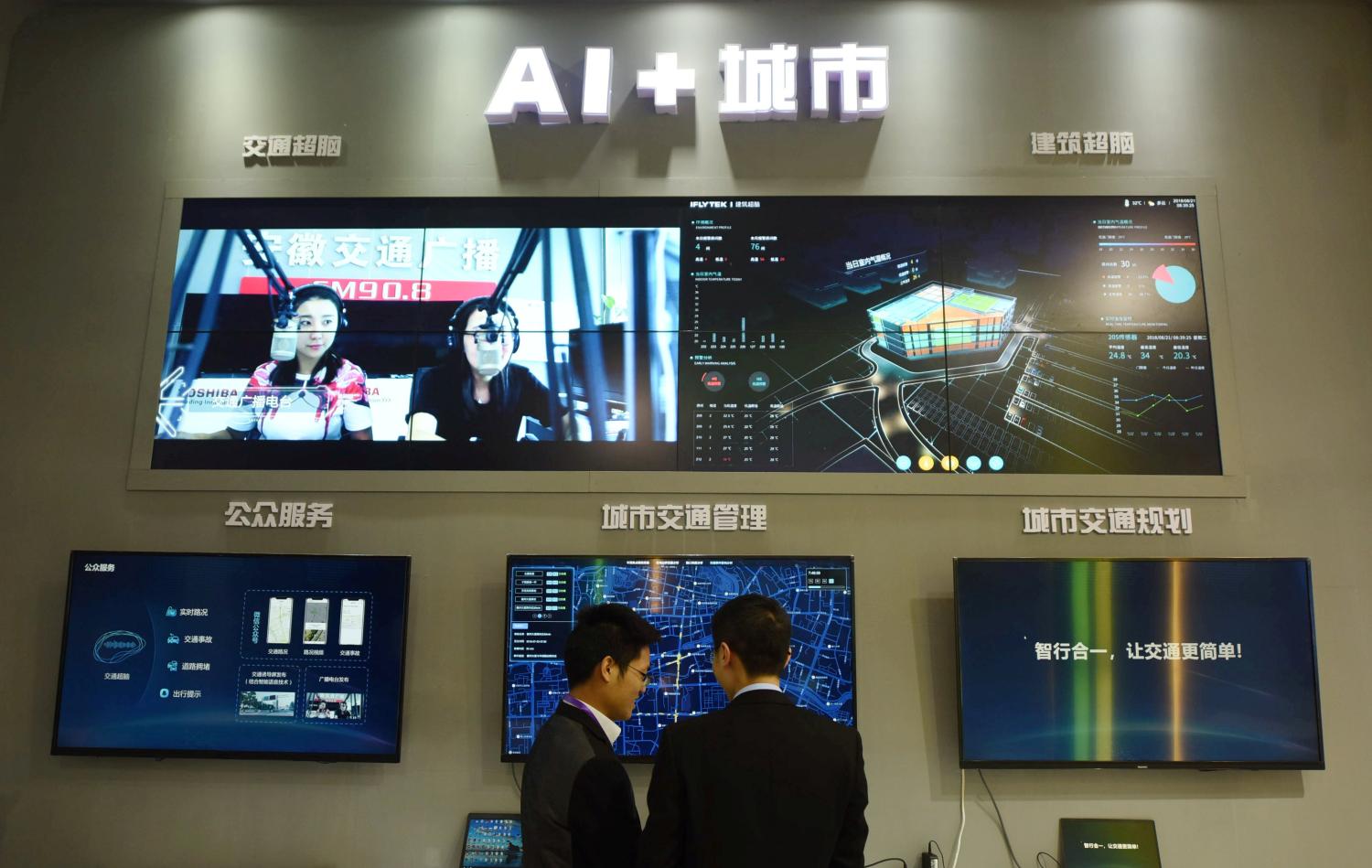Men visit iFlytek's artificial intelligence (AI) smart city display at the International Intelligent Transportation Industry Expo in Hangzhou, Zhejiang province, China December 21, 2018. REUTERS/Stringer  ATTENTION EDITORS - THIS IMAGE WAS PROVIDED BY A THIRD PARTY. CHINA OUT. - RC1E35A070C0