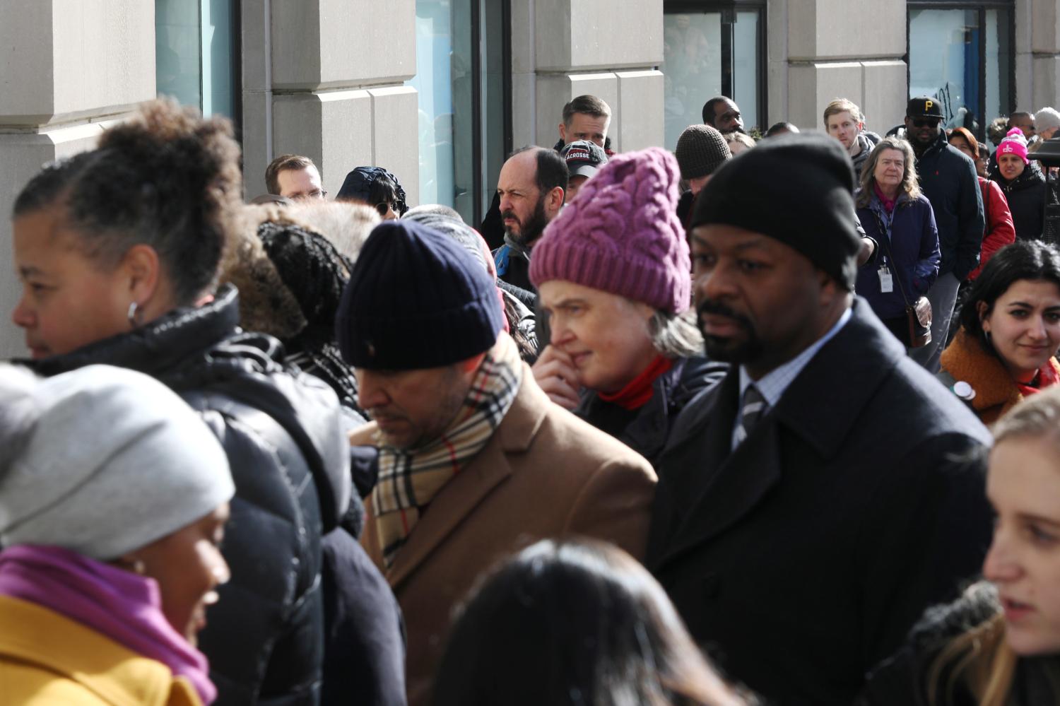 Federal workers left unpaid or furloughed by the extended partial government shutdown stand in line for fresh food and coffee at the World Central Kitchen, a volunteer emergency kitchen run by Chef Jose Andres, in Washington, U.S. January 16, 2019. REUTERS/Jonathan Ernst - RC1E76F9E110