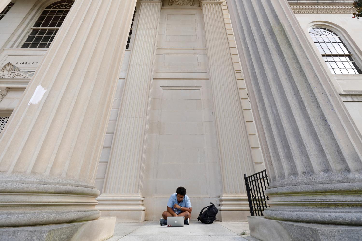 A student works outside Wilson Library on the campus of the University of North Carolina at Chapel Hill, North Carolina, U.S., September 20, 2018. Picture taken on September 20, 2018.  REUTERS/Jonathan Drake - RC1B0CCBA810