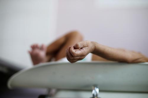 A malnourished boy lies on a weighing scale at the malnutrition ward of al-Sabeen hospital in Sanaa, Yemen September 11, 2018. Picture taken September 11, 2018. REUTERS/Khaled Abdullah - RC1D4DBA52B0