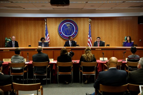 Chairman Ajit Pai (C) leads a vote on the repeal of so called net neutrality rules at the Federal Communications Commission in Washington, U.S., December 14, 2017. REUTERS/Aaron P. Bernstein - RC18AF078D70